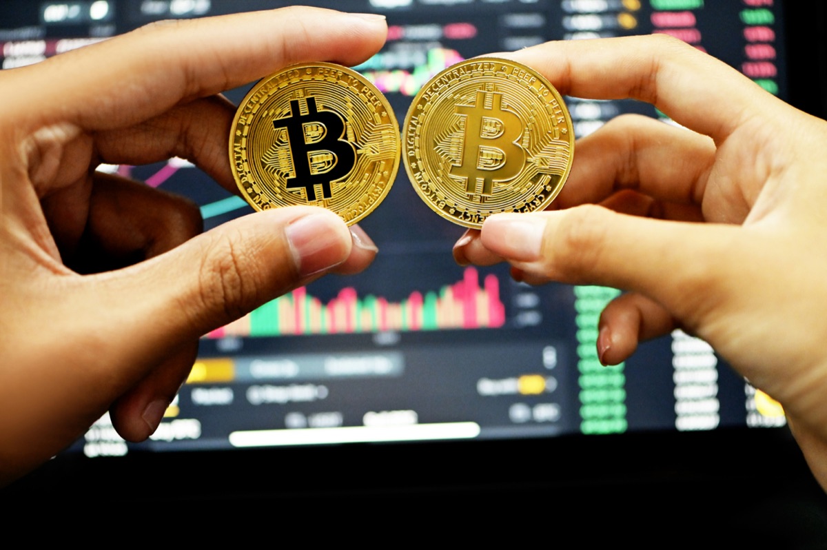 Bitcoin and Ethereum coins in front of a trading chart